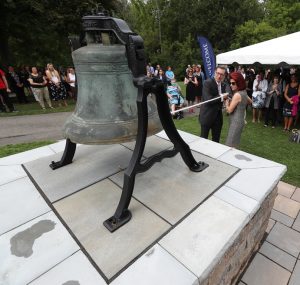 Daemen President Gary Olson and his wife, Dr. Lynn Worsham, participate in the ceremonial ringing of Founders Bell.