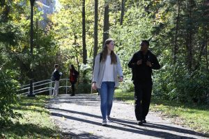 Two students walking on the path behind Canavan Hall. 