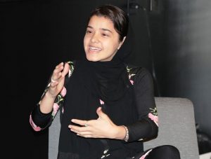 Zahra Arabzada sitting down talking into a microphone