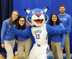 Willy the Wildcat posing with students