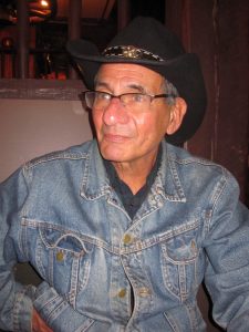 Charlie Sabatino in a denim jacket with a black cowboy hat