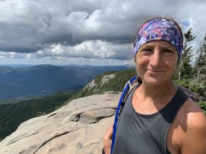 Lynn Matthews ontop of a mountain ridge