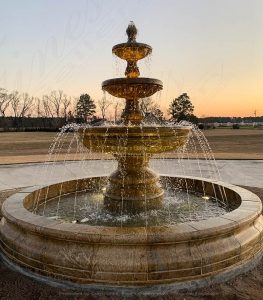 Fountain with sunset visible behind