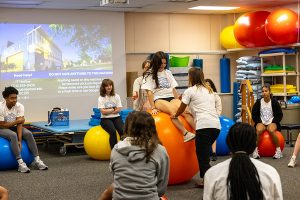 Students at PT Institute working on large therapy ball