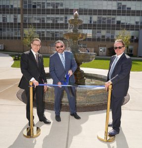 Ribbon cutting in front of Daemen fountain