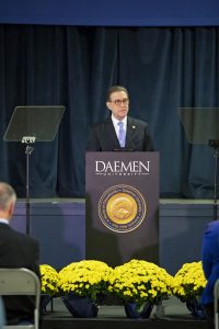 President Gary A. Olson stands at podium delivering the State of the University.