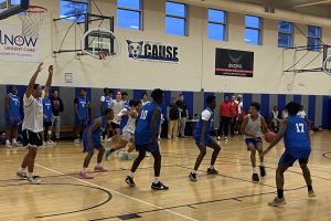 Several basketball players in Daemen's Bieler Center playing a basketball game vs UB