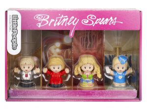 Four Little People toy figures of Britney Spears wearing different outfits packaged in pink package with Little People logo on it.