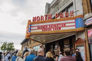 Image of the North Park Theatre marquis with "Daemen Animation Senior Show" on it with a crowd of people in front of the theater