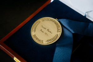 Presidential medal with navy ribbon displayed in a case