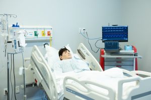 Simulated hospital room with a manikin patient lying in bed