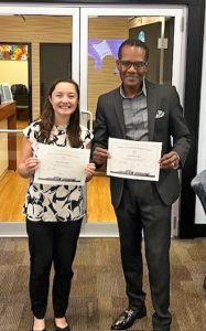 African American man dressed in a suit and a woman dressed in business attire both holding certificates