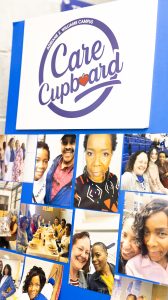 Photo collage of multiple photos of people together smiling and laughing on a blue piece of poster board with a Care Cupboard sign at the top