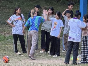 A group of students standing together, some high-fiving each other