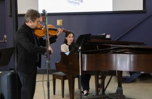 Woman playing the piano and a man playing the viola