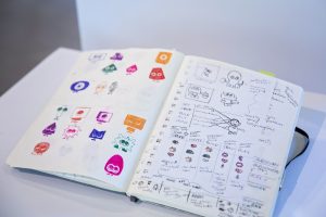 Open notebook with sketches in black and white and various colors