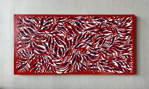 Large rectangular red, white and blue metal artwork hanging on a wall