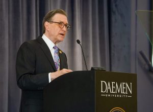 President Olson standing behind a podium speaking to an audience